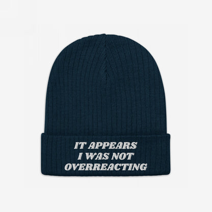 Dark-navy rib-knit beanie titled No More Wars Hat with folded cuff, featuring off-white embroidered text: It appears I was not overreacting, symbolizing an anti-war stance.