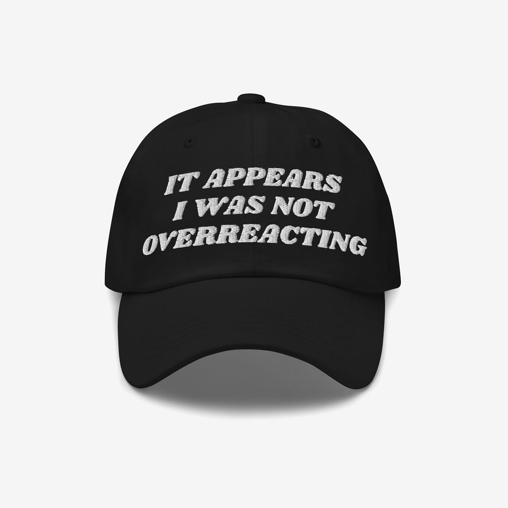 Black Overreacting Hat with white embroidered text, IT APPEARS I WAS NOT OVERREACTING, signifies anti-fascist sentiment. Ideal for progressive activism, available in various styles, supporting ACLU initiatives.