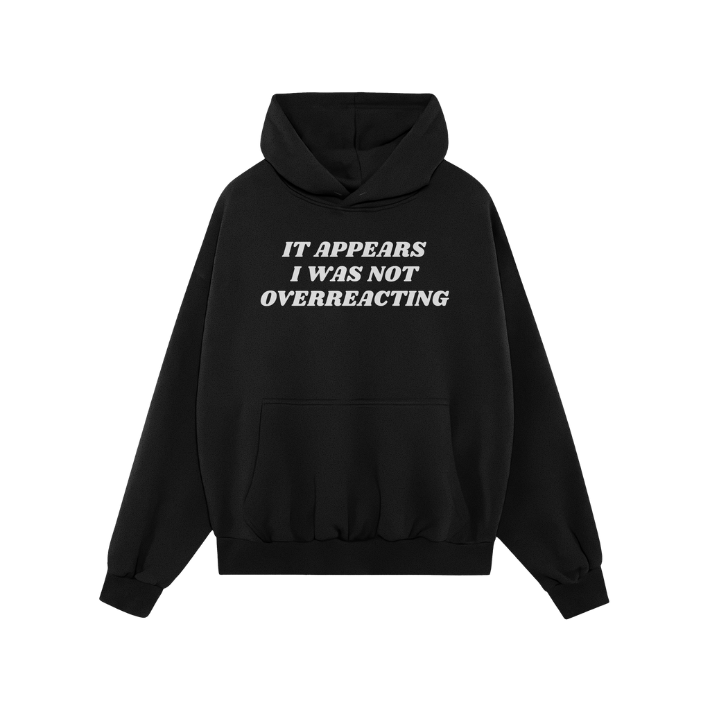 Black hoodie with kangaroo pocket featuring It Appears I Was Not Overreacting in white, symbolizing resistance against fascis