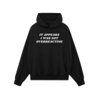 Black hoodie with kangaroo pocket featuring It Appears I Was Not Overreacting in white, symbolizing resistance against fascis