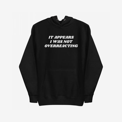 Overreacting Hoodie & Sweatshirt features bold white text asserting IT APPEARS I WAS NOT OVERREACTING, on a black pullover, embodying resistance and truth against oppression. Perfect for those challenging systemic injustices.