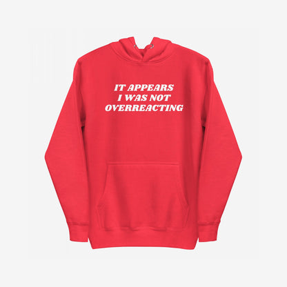 Overreacting Hoodie & Sweatshirt features bold white lettering stating “IT APPEARS I WAS NOT OVERREACTING.”, embodying a message of resistance and unapologetic critique against oppressive systems.