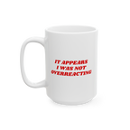 White ceramic mug with red text: IT APPEARS I WAS NOT OVERREACTING. The Overreacting Mug boldly communicates anti-fascist sen