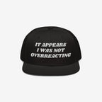 The Overreacting Hat is a black snapback with white embroidery reading It appears I was not overreacting, symbolizing resistance to fascism and supporting progressive values.