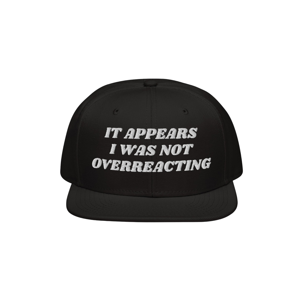 The Overreacting Hat is a black snapback with white embroidery reading It appears I was not overreacting, symbolizing resista