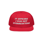 The Overreacting Hat features bold white embroidery on a red flat-brim cap, designed for progressives advocating against extr