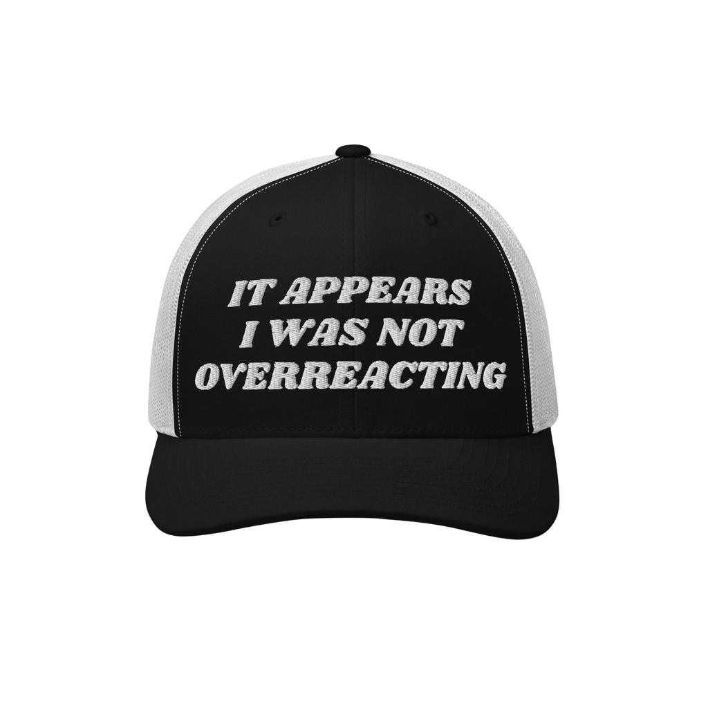 Overreacting Hat: A black-and-white mesh trucker cap with It Appears I Was Not Overreacting in raised white embroidery, symbo