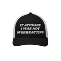Overreacting Hat: A black-and-white mesh trucker cap with It Appears I Was Not Overreacting in raised white embroidery, symbo