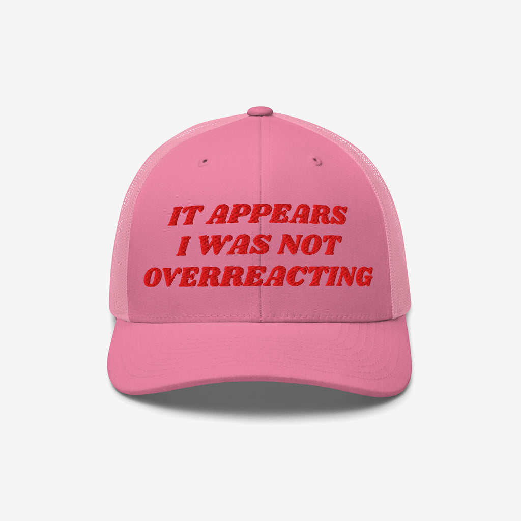 Pink trucker-style cap with red embroidered text: It Appears I Was Not Overreacting, symbolizing resistance against fascism and political gaslighting, supporting progressive activism and ACLU donations.
