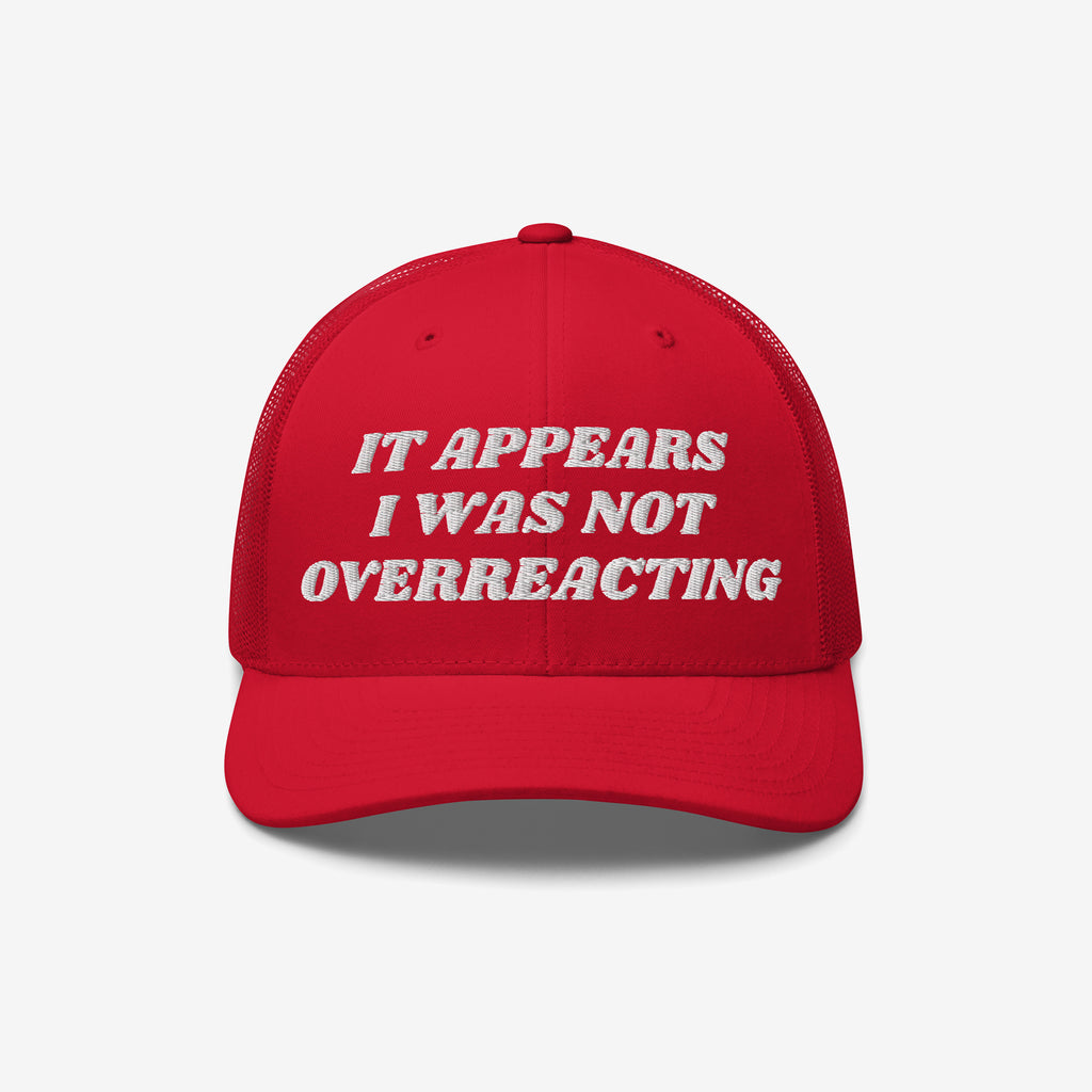 Red trucker-style Overreacting Hat with white embroidered text “IT APPEARS I WAS NOT OVERREACTING,” symbolizing anti-fascist sentiments, designed for progressives opposing extremism and political gaslighting.