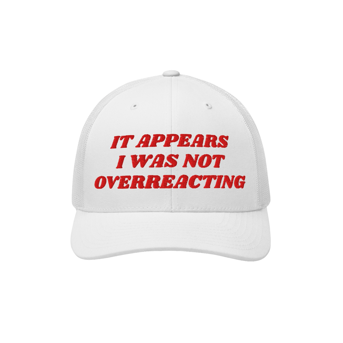 White mesh-back trucker cap, solid front with bold red embroidery: “IT APPEARS I WAS NOT OVERREACTING.” The Overreacting 