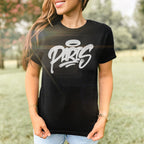 Woman outdoors wearing Paris Handstyle Women's Baby Tee: black with white graffiti PARIS and halo tag. Styled with light-wash jeans, bracelets, and rings, embodying bold, artistic expression.