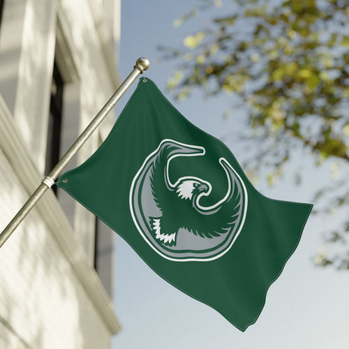 Philly Rebel Alliance Flag featuring a stylized eagle in mid-flight, outlined in white on dark green, mounted outside. Emblem symbolizes protest and equality, resonating with anti-fascist and immigrant rights advocacy.