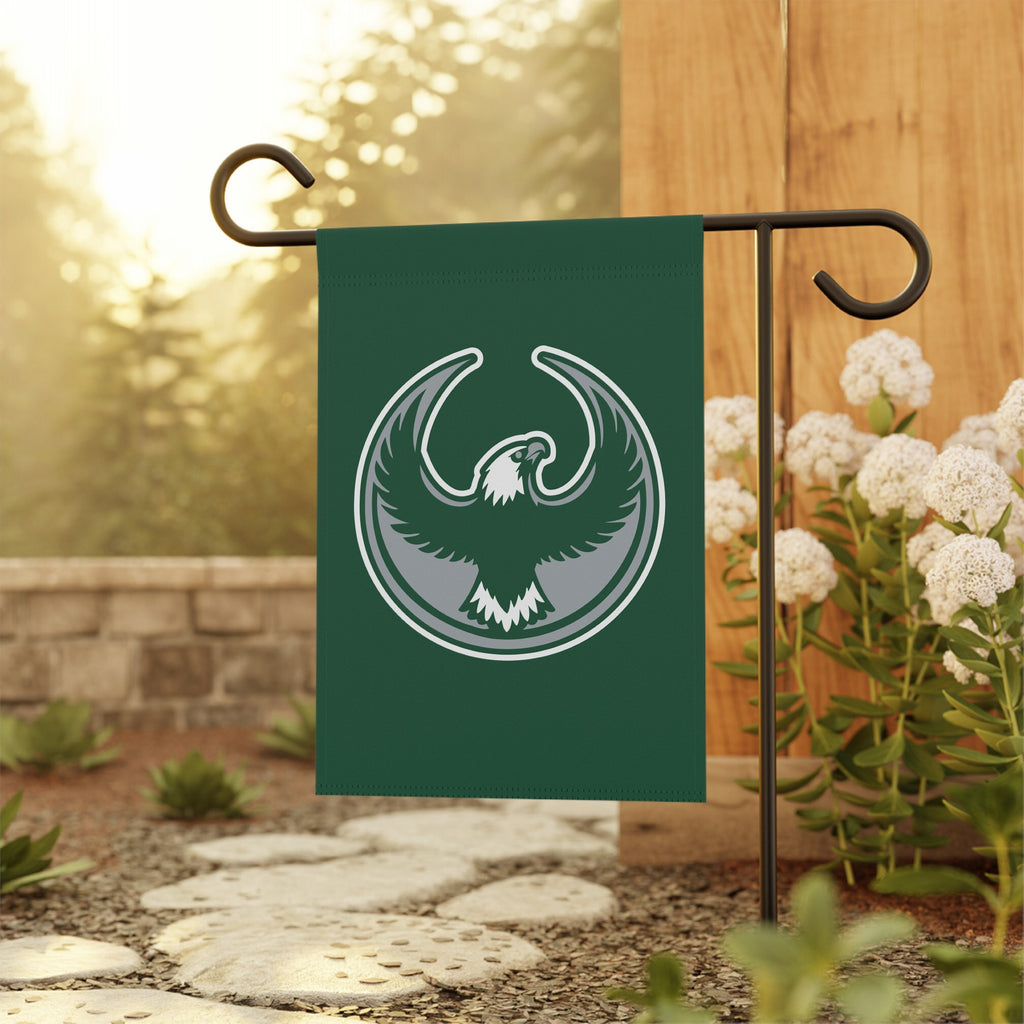 Philly Rebel Alliance Garden Flag featuring a stylized eagle emblem on a deep green background, displayed on a black metal stand, ideal for showcasing support for immigrant rights and equality.