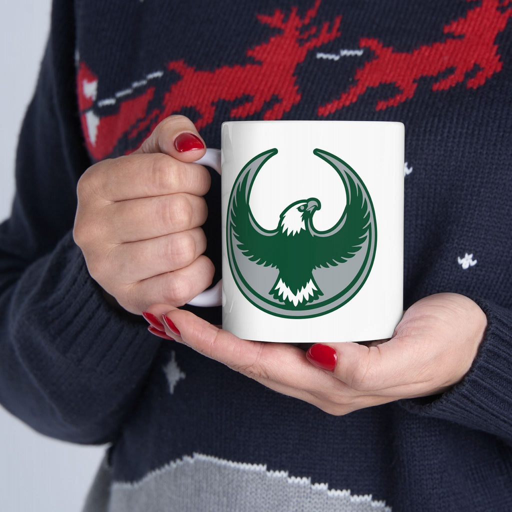 Person holding a Philly Rebel Alliance Mug, featuring a green eagle emblem. The mug symbolizes resistance and support for equality, perfect for activists and as a Philadelphia keepsake.