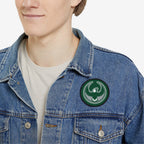 Person wearing a light-wash denim jacket adorned with the Philly Rebel Alliance Patch, featuring a green and gray eagle emblem, symbolizing anti-fascist energy and support for immigrant rights.