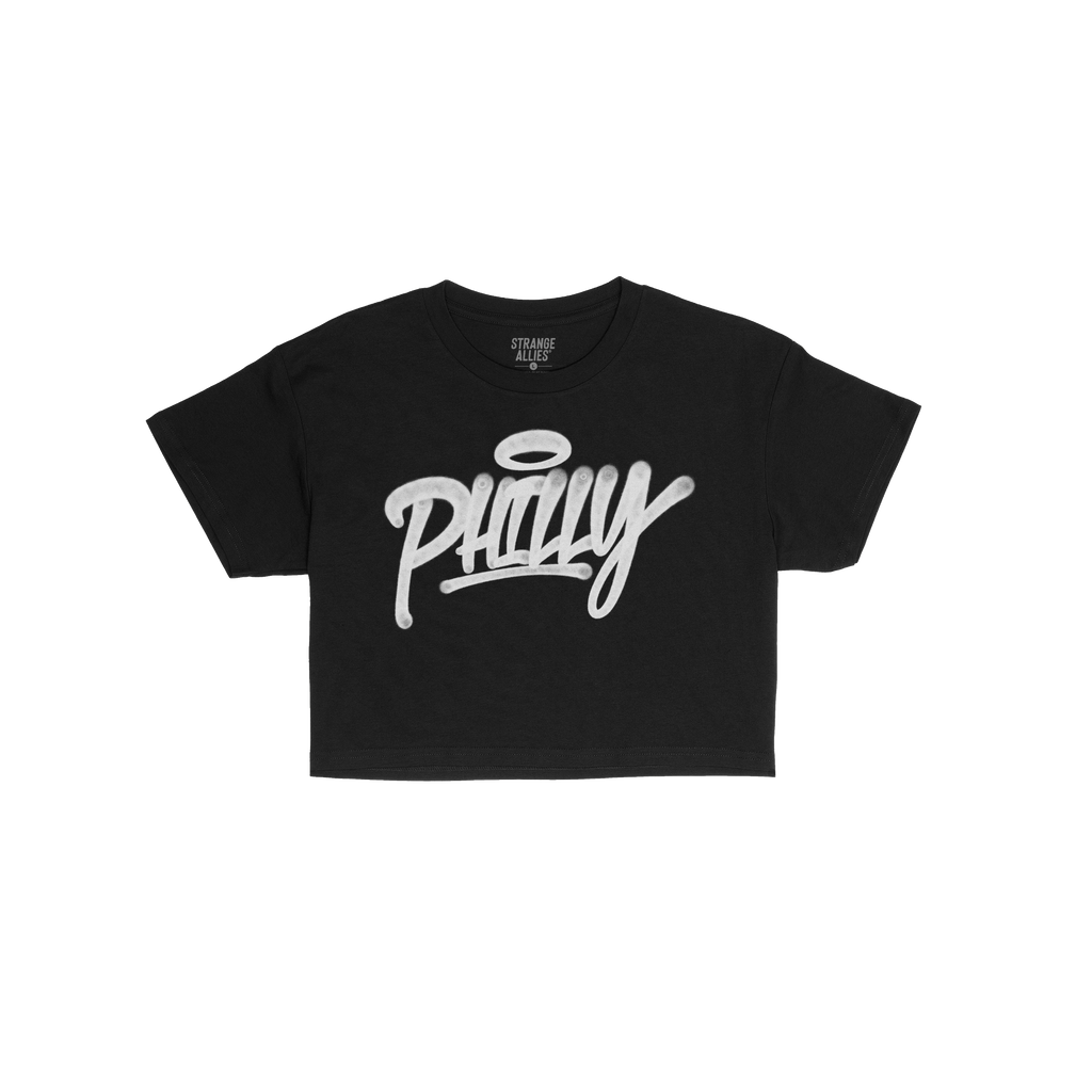 Philadelphia Handstyle Women's Baby Tee featuring bold, white 'Philly' graffiti script with a halo over the 'i', laid flat on