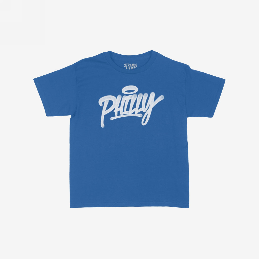 Philadelphia Handstyle Women's Baby Tee features a bold, graffiti-style Philly script with a halo motif on a royal-blue fabric, embodying vibrant city pride and the store's commitment to equality and expression.