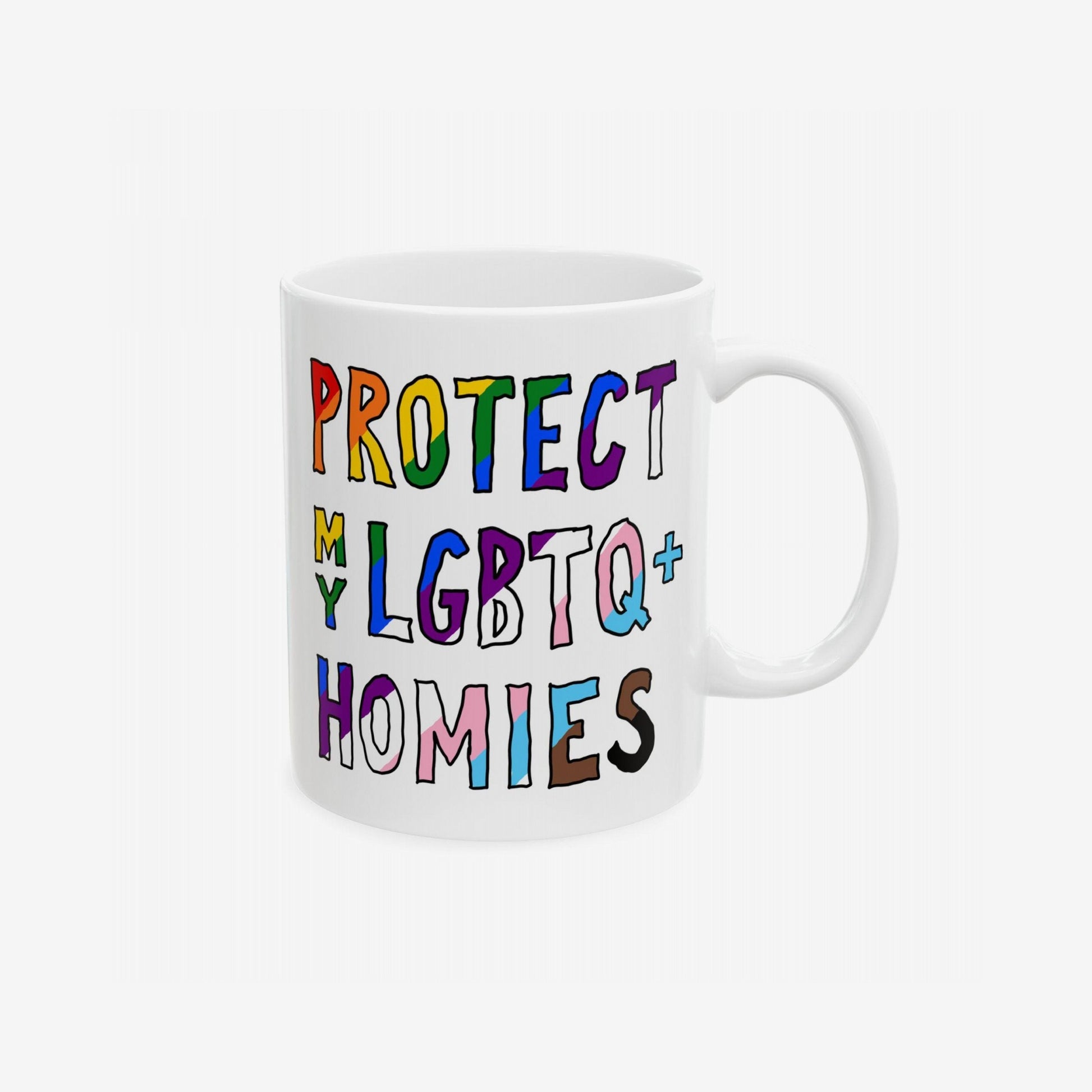 Protect My LGBTQ+ Homies Mug featuring bold, hand-drawn letters in pride colors. The white ceramic mug advocates inclusivity and equality, perfect for allies and supporters, with durable, lead-free ceramic.