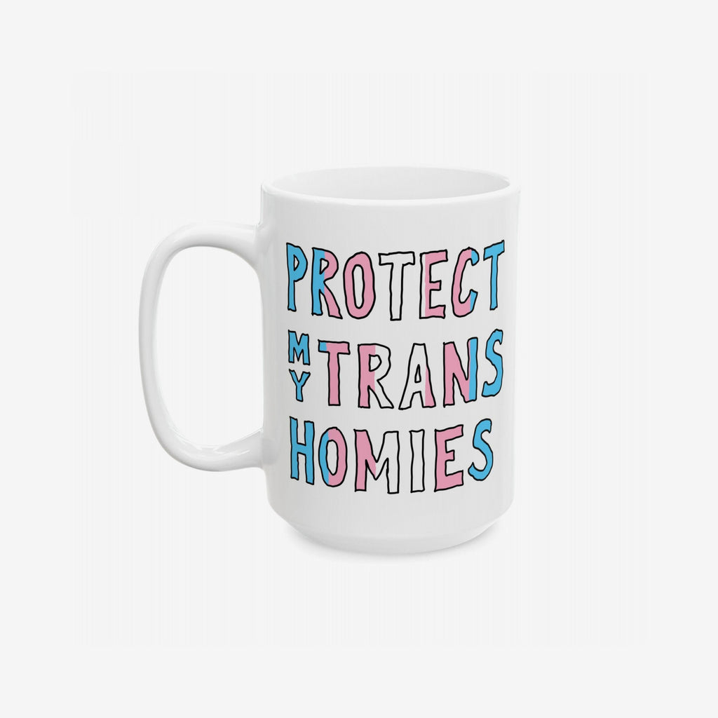 White ceramic Protect My Trans Homies mug with chunky hand-lettered slogan in trans pride colors, advocating for trans rights. A bold, loving statement for morning routines. Dishwasher-safe, available in 11 oz. and 15 oz. sizes.