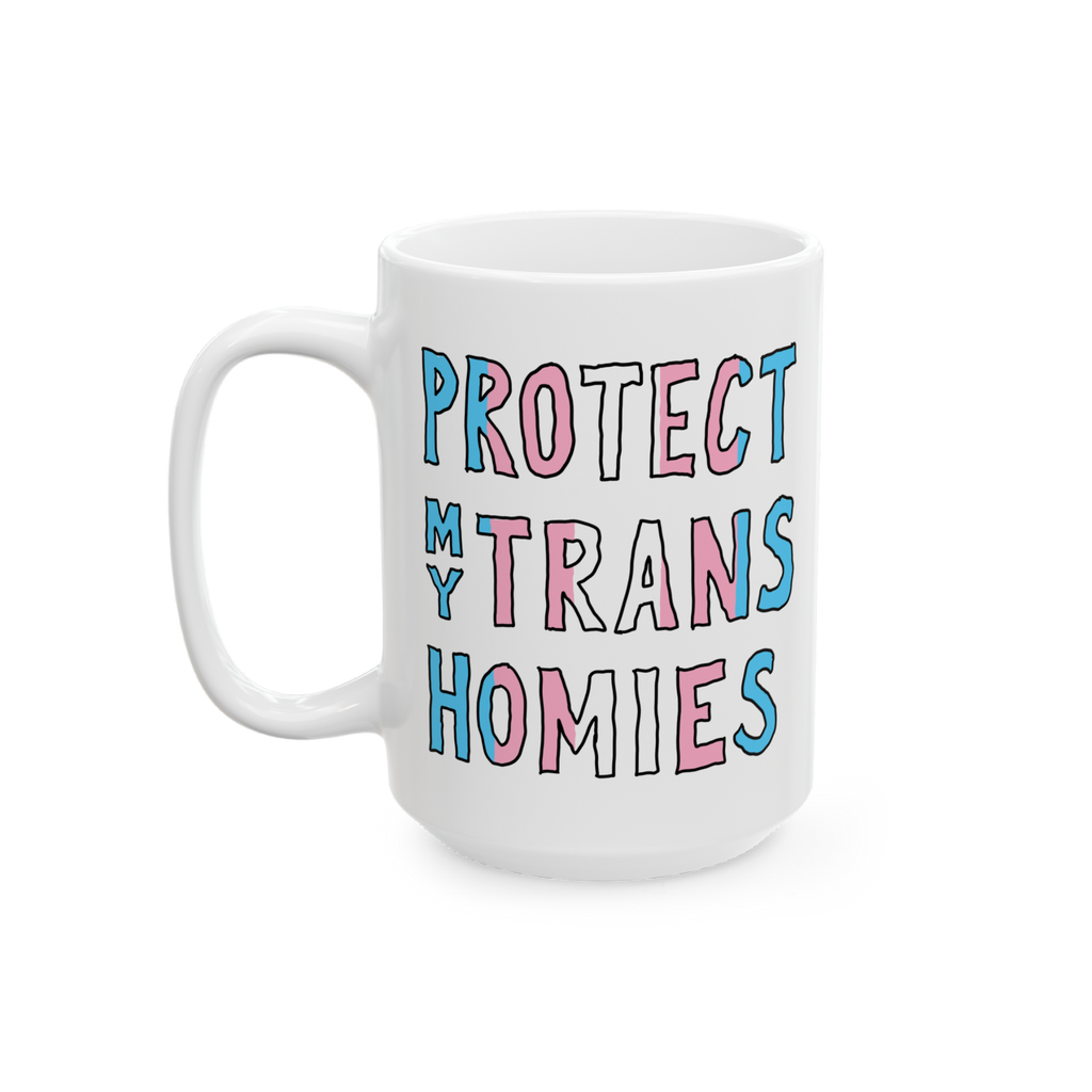White ceramic Protect My Trans Homies mug with chunky hand-lettered slogan in trans pride colors, advocating for trans rights