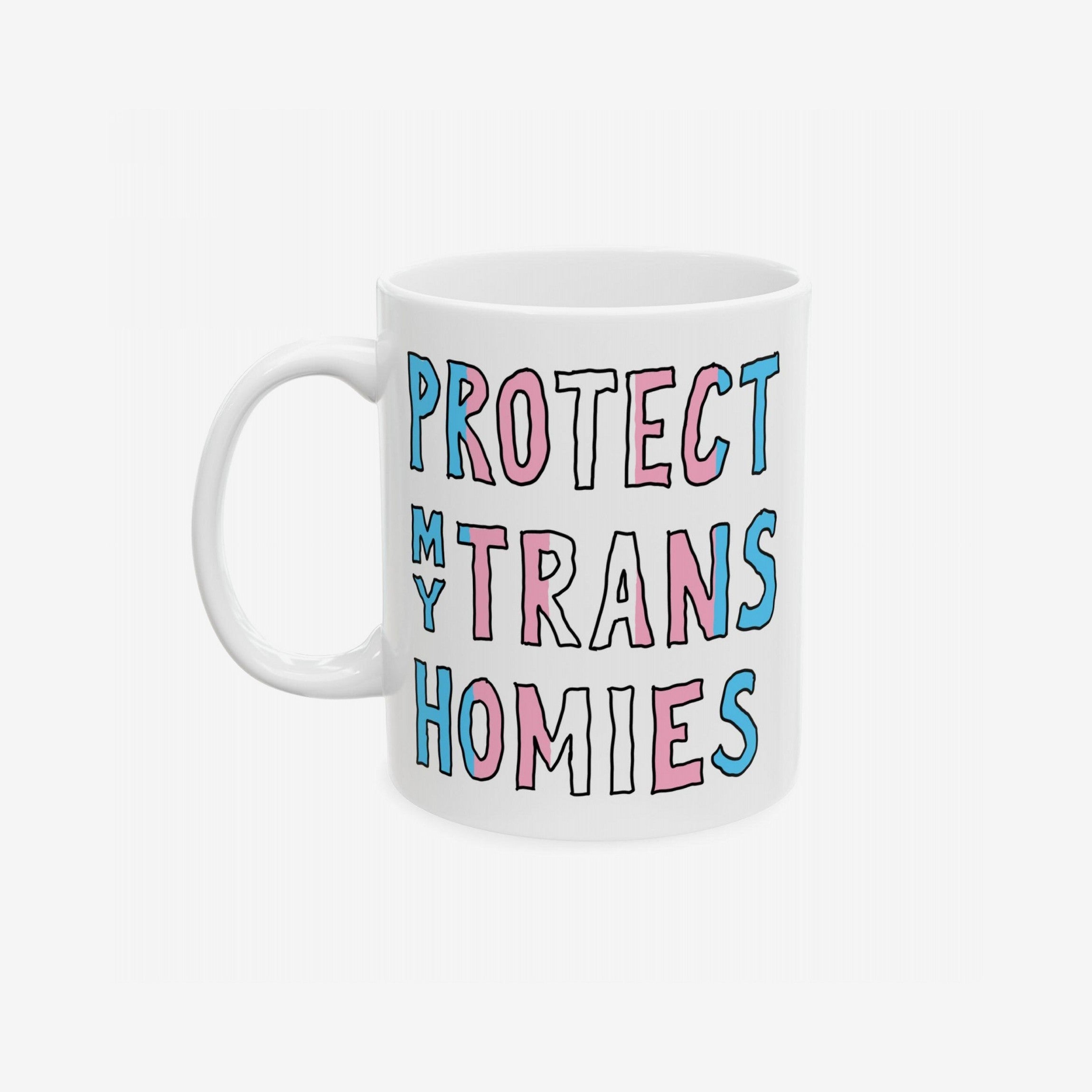 Protect My Trans Homies Mug with hand-drawn slogan in pink, white, and light blue. This ceramic mug champions transgender rights, blending bold design with practicality. Available in 11 oz. and 15 oz. sizes.