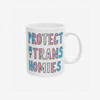 Protect My Trans Homies Mug features hand-drawn lettering in pride colors, symbolizing solidarity and support for trans rights. This ceramic mug is dishwasher-safe and available in 11 oz. and 15 oz. sizes.
