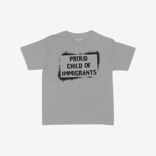 Proud Child Of Immigrants Women's Baby Tee features a bold black stencil-style print on a light-gray T-shirt, celebrating cultural heritage and identity with a modern Y2K streetwear vibe.