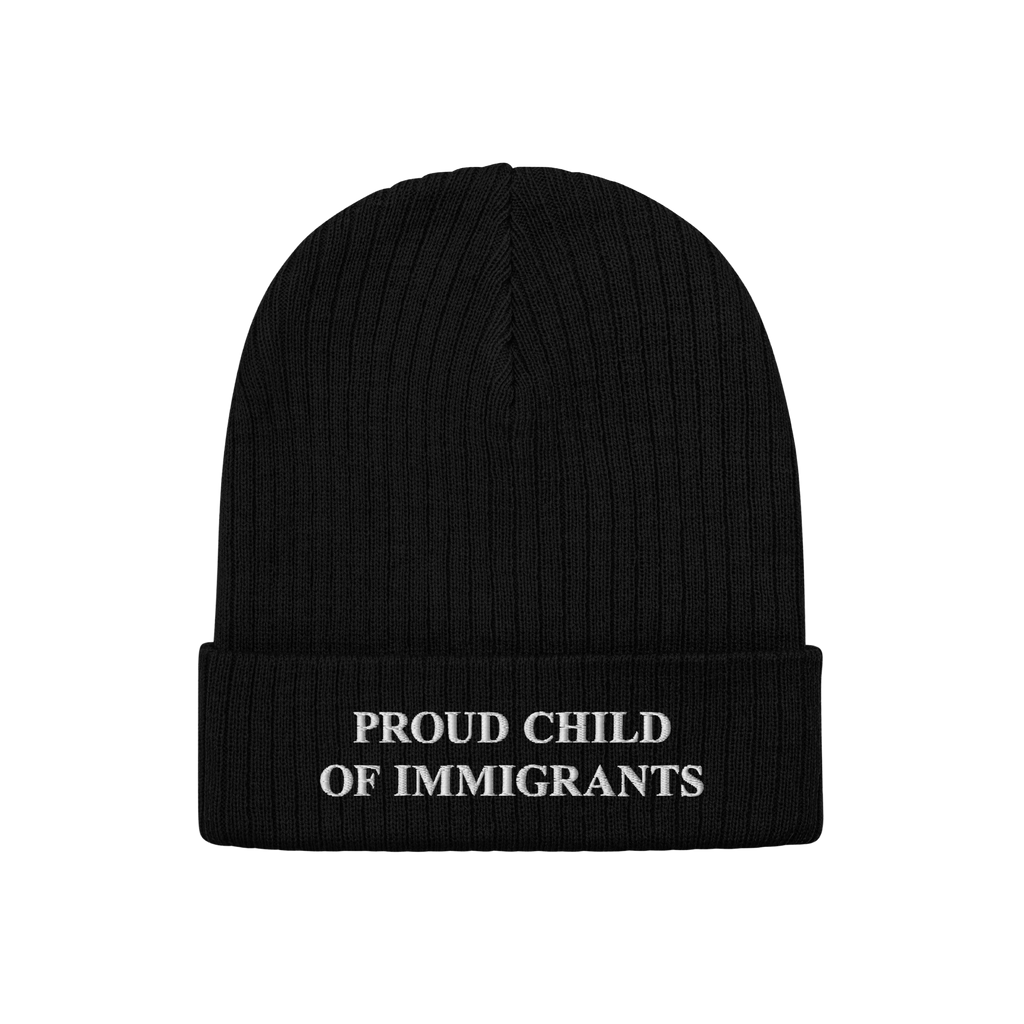 Black rib-knit beanie with “PROUD CHILD OF IMMIGRANTS” embroidered in white, symbolizing identity and heritage. A stateme