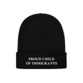 Black rib-knit beanie with “PROUD CHILD OF IMMIGRANTS” embroidered in white, symbolizing identity and heritage. A stateme