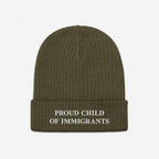 Proud Child Of Immigrants Hat: An olive-green rib-knit beanie with PROUD CHILD OF IMMIGRANTS embroidered on the brim, symbolizing identity, resilience, and heritage.