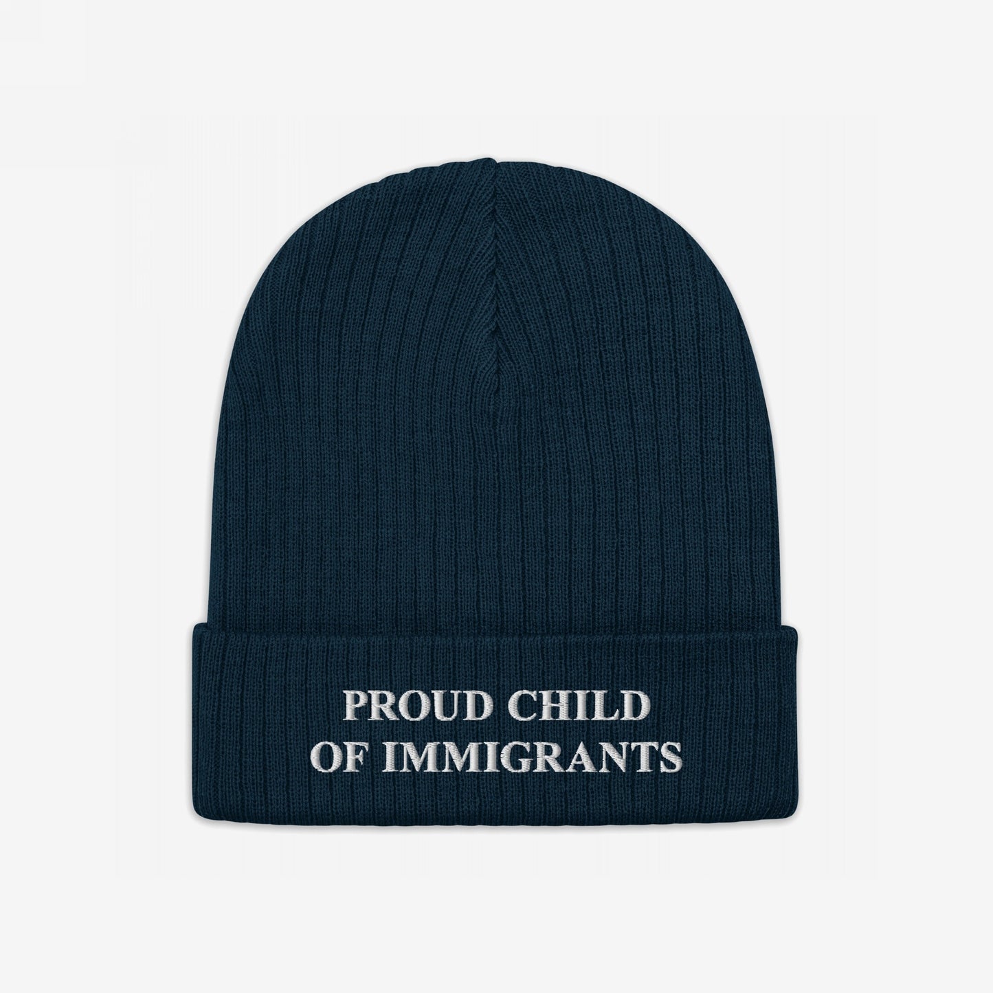 Navy-blue beanie with “PROUD CHILD OF IMMIGRANTS” in white embroidery on the cuff, symbolizing identity and heritage. The Proud Child Of Immigrants Hat embodies resilience and pride.