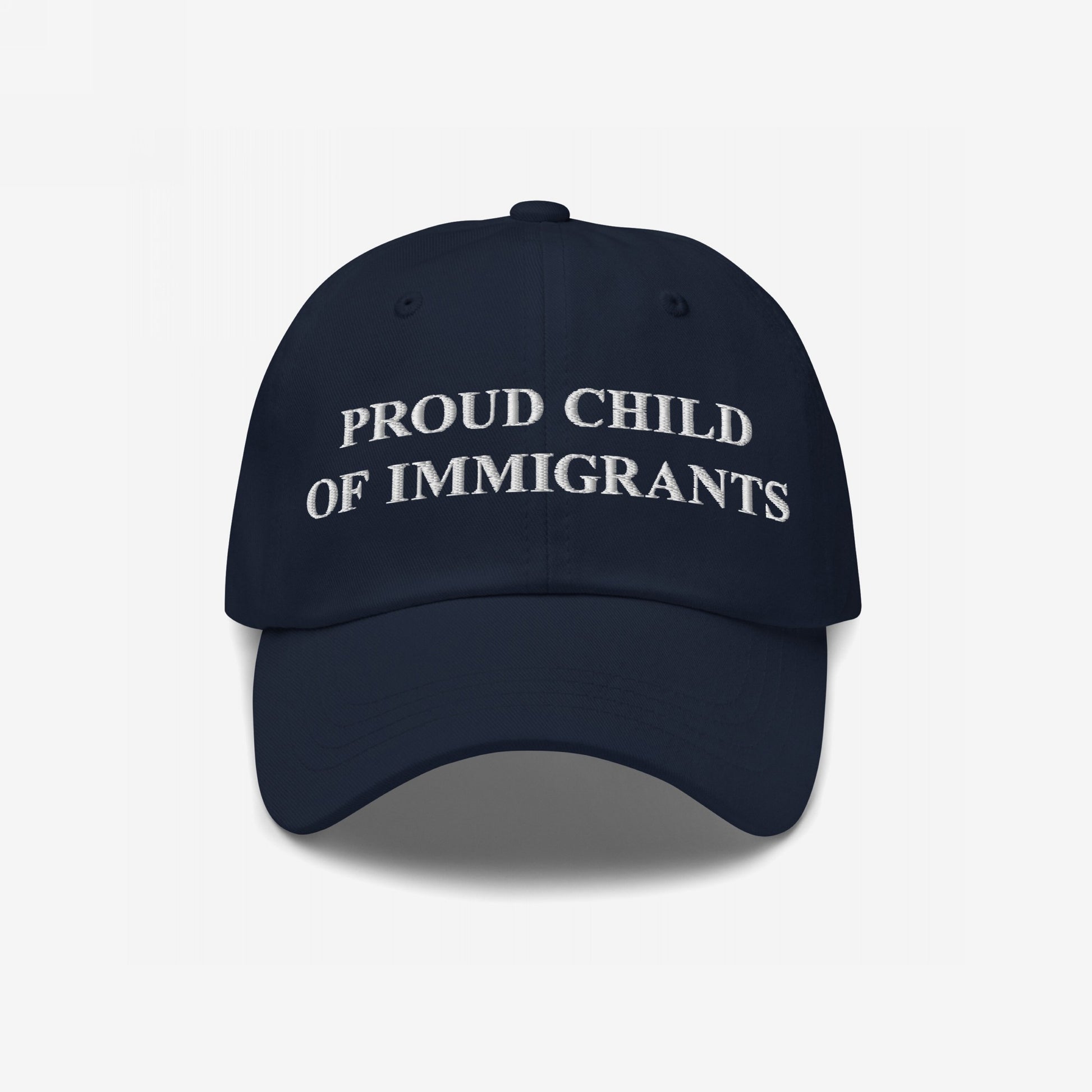 Proud Child of Immigrants Hat features white embroidered lettering, symbolizing identity and heritage, perfect for those honoring their family's journey with pride and resilience.