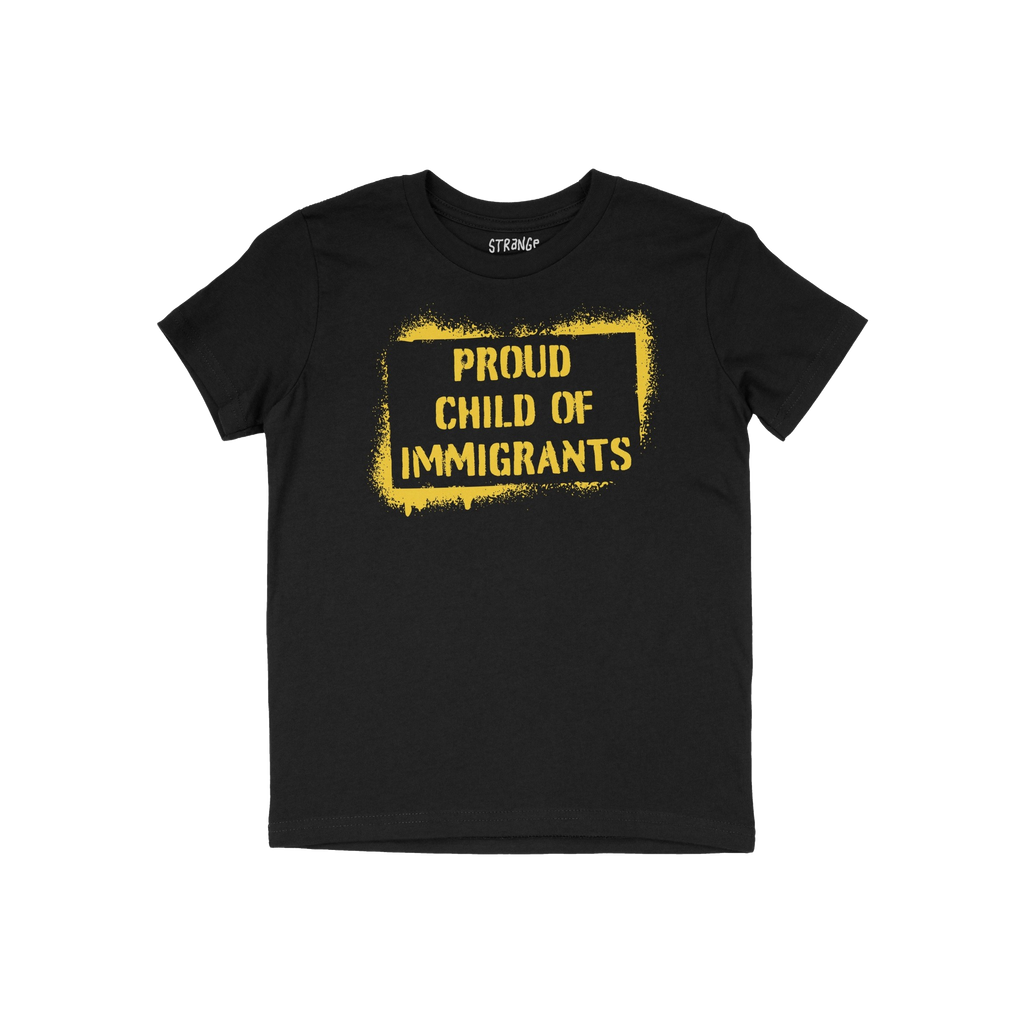 Black T-shirt featuring bold, yellow stencil-style text: PROUD CHILD OF IMMIGRANTS within a painted rectangle, symbolizing de