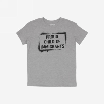 Heather-gray T-shirt with a bold black stencil graphic reading PROUD CHILD OF IMMIGRANTS, symbolizing resilience and defiance. Ideal for those challenging oppressive systems and celebrating immigrant heritage.
