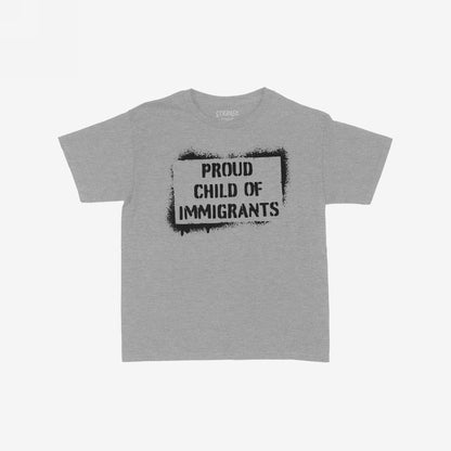 Light-grey T-shirt with PROUD CHILD OF IMMIGRANTS in black stencil font, emphasizing heritage and belonging, aligned with art and equality-focused ethos. Short-sleeved and available for adults and kids.