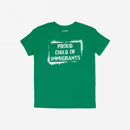 The Proud Child Of Immigrants T-shirt features bold white stencil lettering across the chest, celebrating resilience and legacy. Laid flat, it represents defiance and pride against oppressive systems.