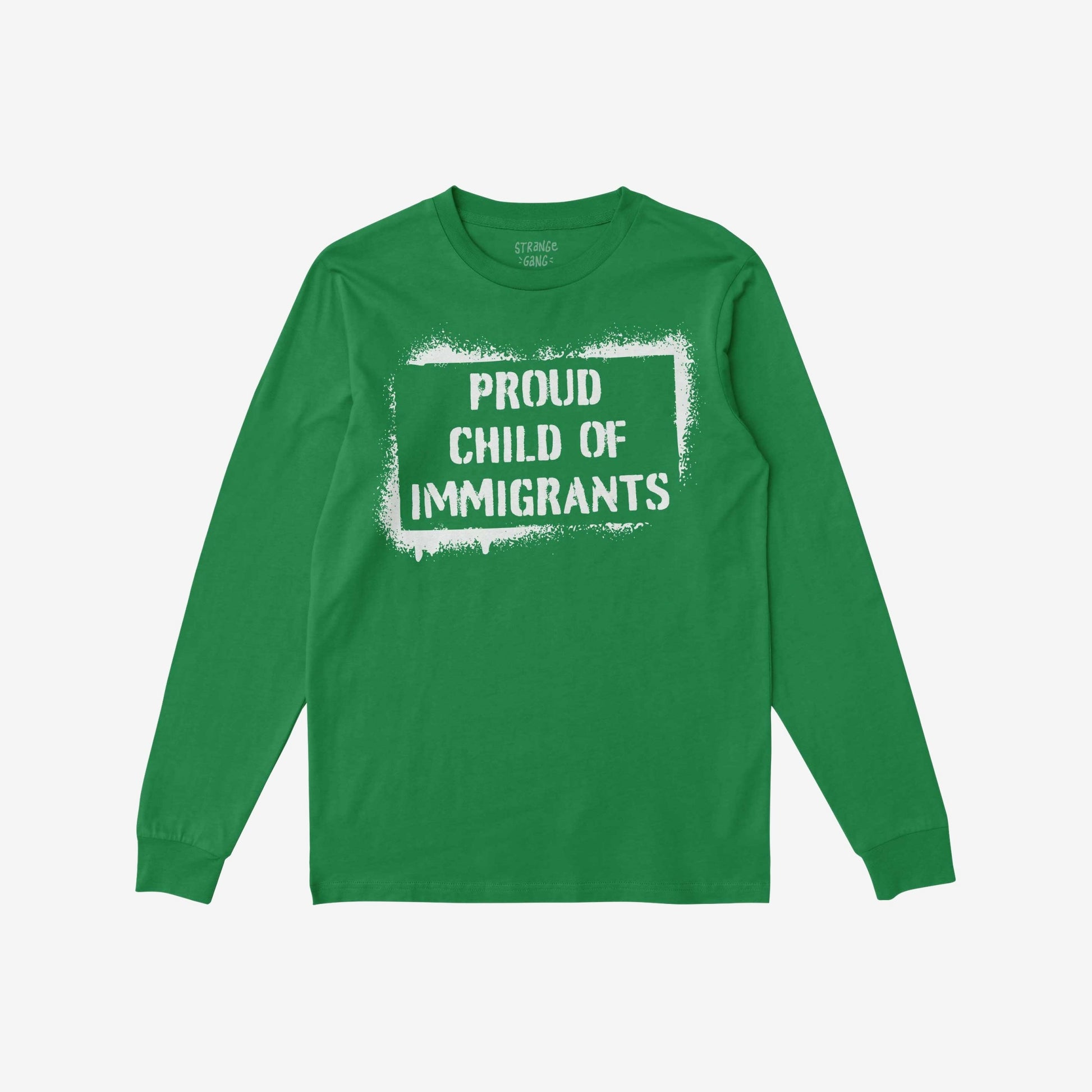 Green long-sleeved T-shirt flat with white stencil graphic stating “PROUD CHILD OF IMMIGRANTS” inside a rough border, embodying cultural pride and belonging.