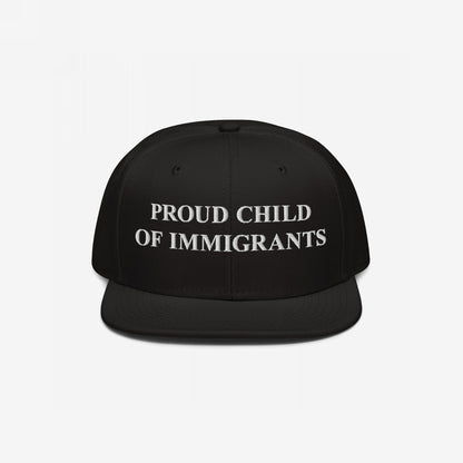 The Proud Child Of Immigrants Hat features bold, white embroidery on a black snap-back cap, symbolizing heritage and resilience, perfect for those honoring their immigrant roots with pride.