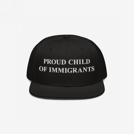 The Proud Child Of Immigrants Hat features bold, white embroidery on a black snap-back cap, symbolizing heritage and resilience, perfect for those honoring their immigrant roots with pride.