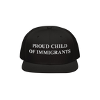The Proud Child Of Immigrants Hat features bold, white embroidery on a black snap-back cap, symbolizing heritage and resilien