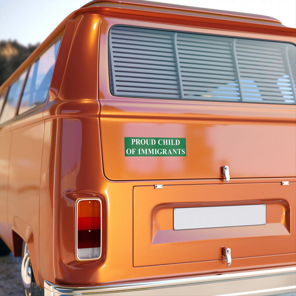 Proud Child Of Immigrants Sticker & Magnet displayed on an orange van, featuring bold green text on its rear hatch. The design symbolizes heritage pride and resistance against anti-immigrant sentiments.