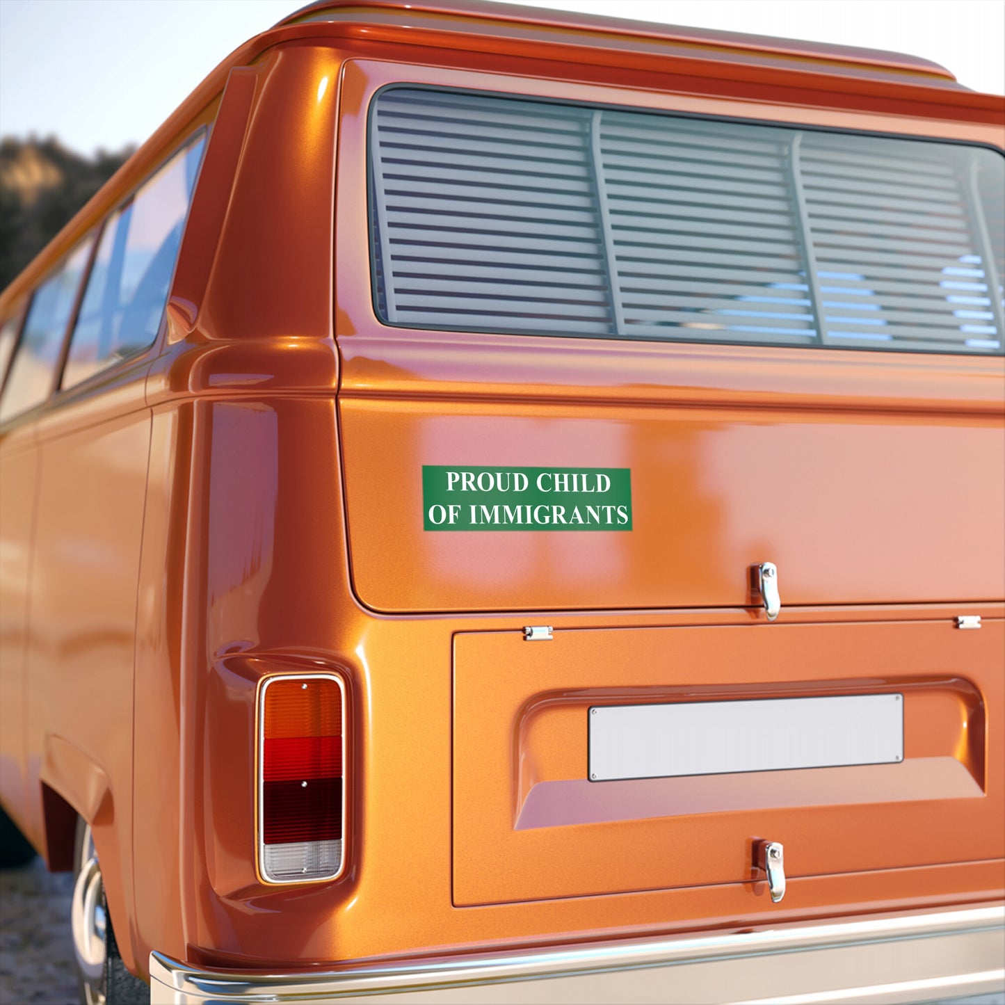 Proud Child Of Immigrants Sticker & Magnet displayed on an orange van, featuring bold green text on its rear hatch. The design symbolizes heritage pride and resistance against anti-immigrant sentiments.