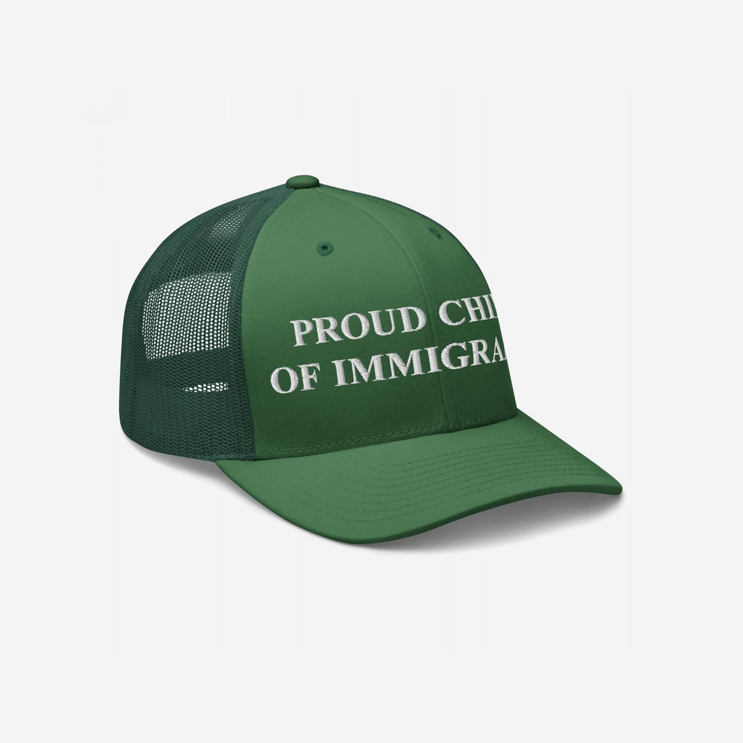Green trucker cap with mesh back, featuring PROUD CHILD OF IMMIGRANTS embroidered in white on the front, symbolizing pride and resilience, aligned with values of equality and justice.