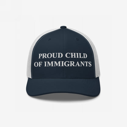 Navy-blue and white mesh trucker cap with PROUD CHILD OF IMMIGRANTS embroidered in white, symbolizing identity and resilience, aligning with themes of equality and pride.