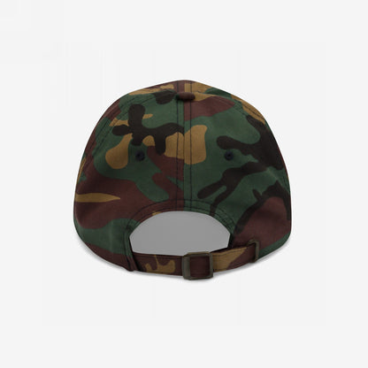 Rear view of the Radical Left Hat in woodland camouflage, featuring a fabric strap with metal buckle. This baseball cap embodies a rebellious spirit with a laid-back fit and progressive message.