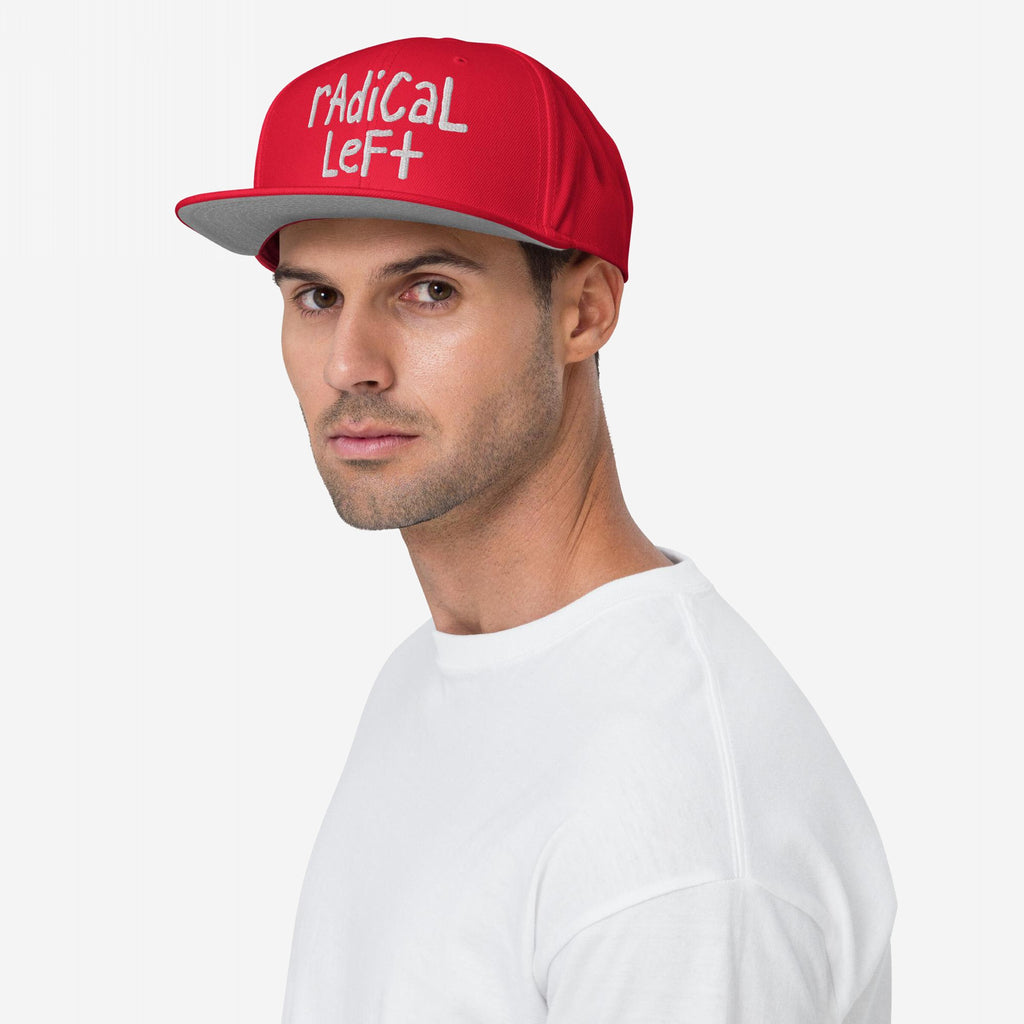 Young man wearing the Radical Left Hat, a bright red baseball cap with radical left in white, symbolizing progressive values and human rights advocacy. Perfect for those supporting equality and justice.