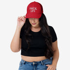 Young woman in a rAdiCaL LeFT hat, tilting the brim down. The cap’s bold message aligns with supporting equality and challenging fascism, embodying progressive values through wearable activism.