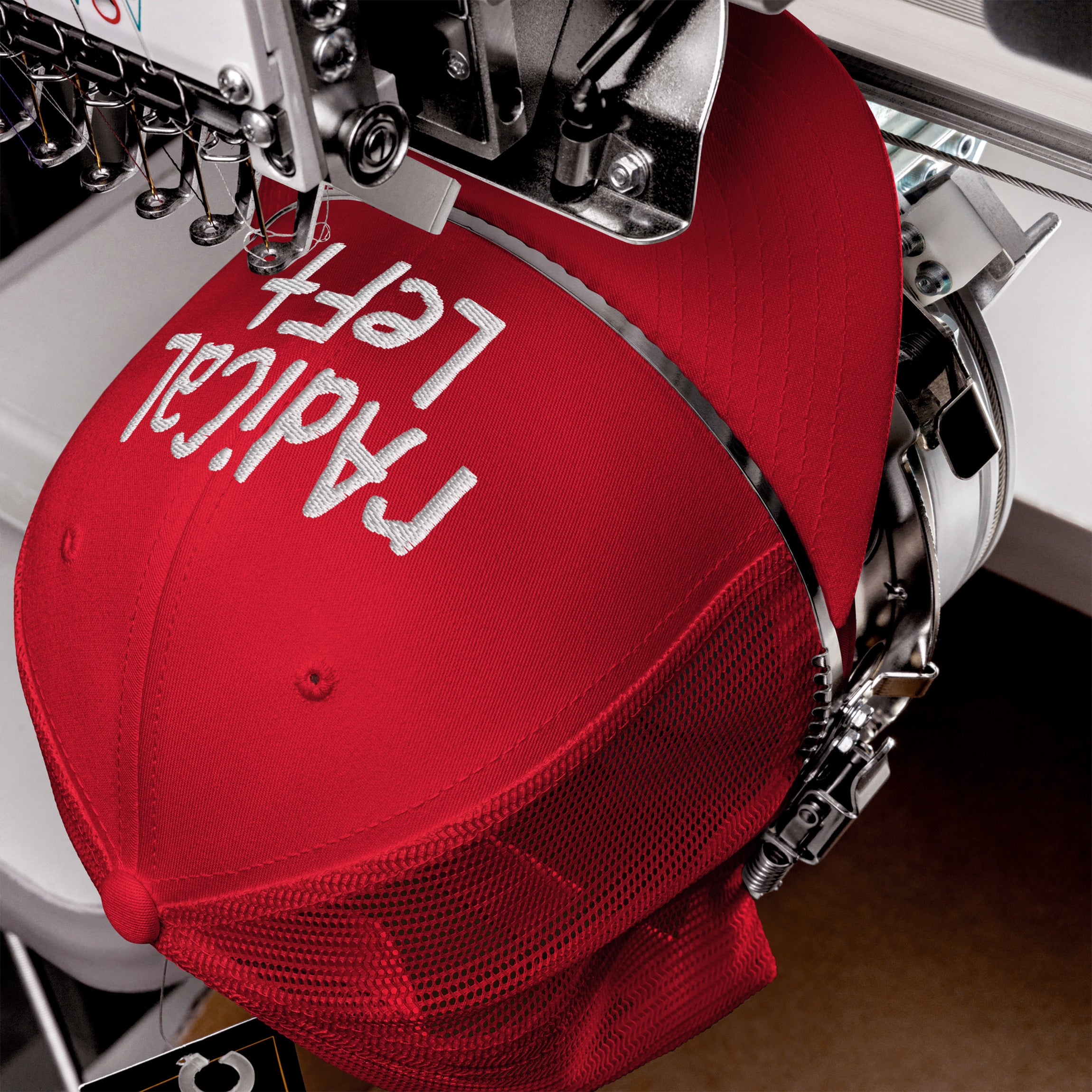 The Radical Left Hat in a machine, white thread stitches its message. This cap embodies progressive values and rebellion, blending hand-drawn embroidery with a defiant front panel statement.