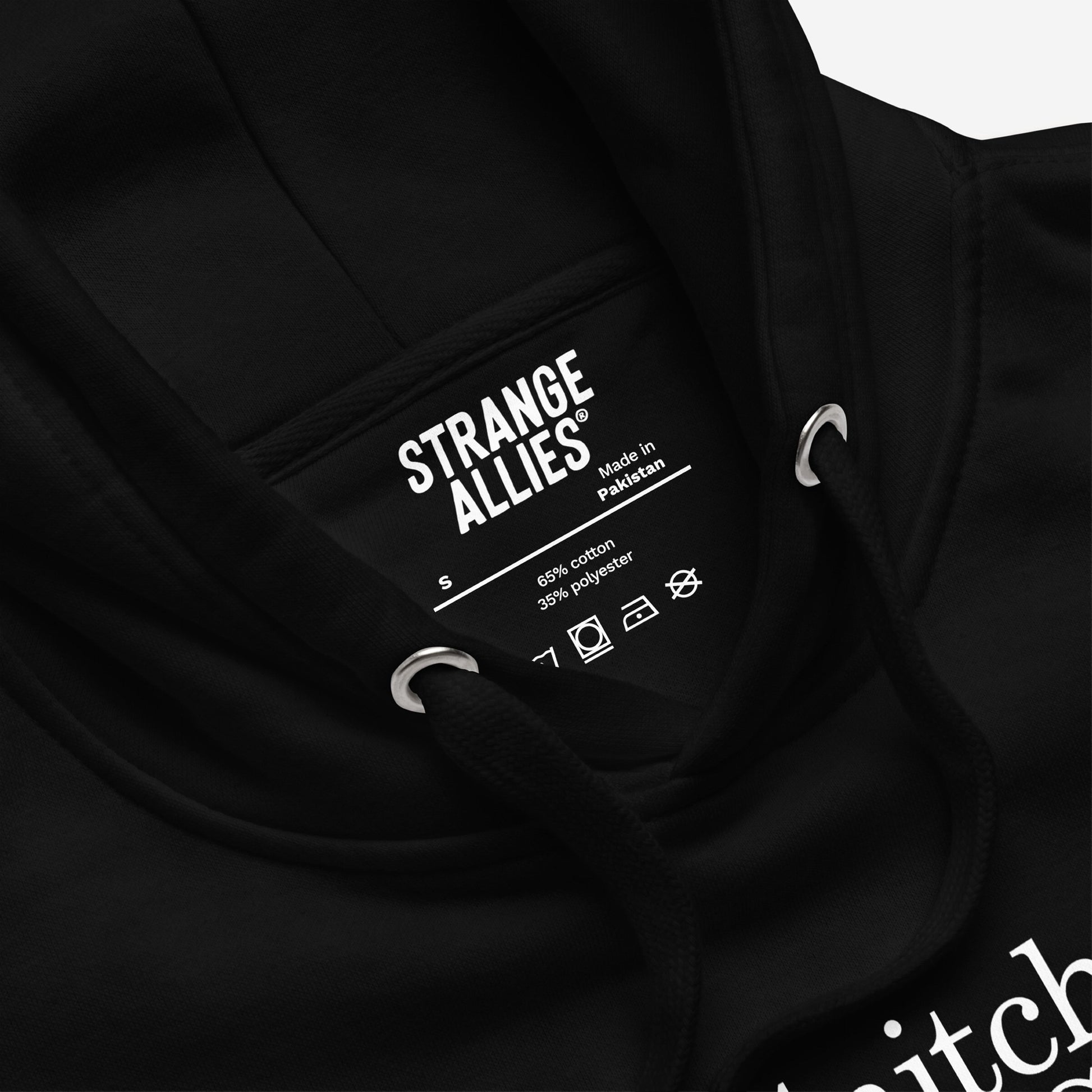 Snitches Get Stitches Hoodie close-up showing the black drawcords, neck label with STRANGE ALLIES®, and a glimpse of the bold white text design, ideal for sarcasm lovers.